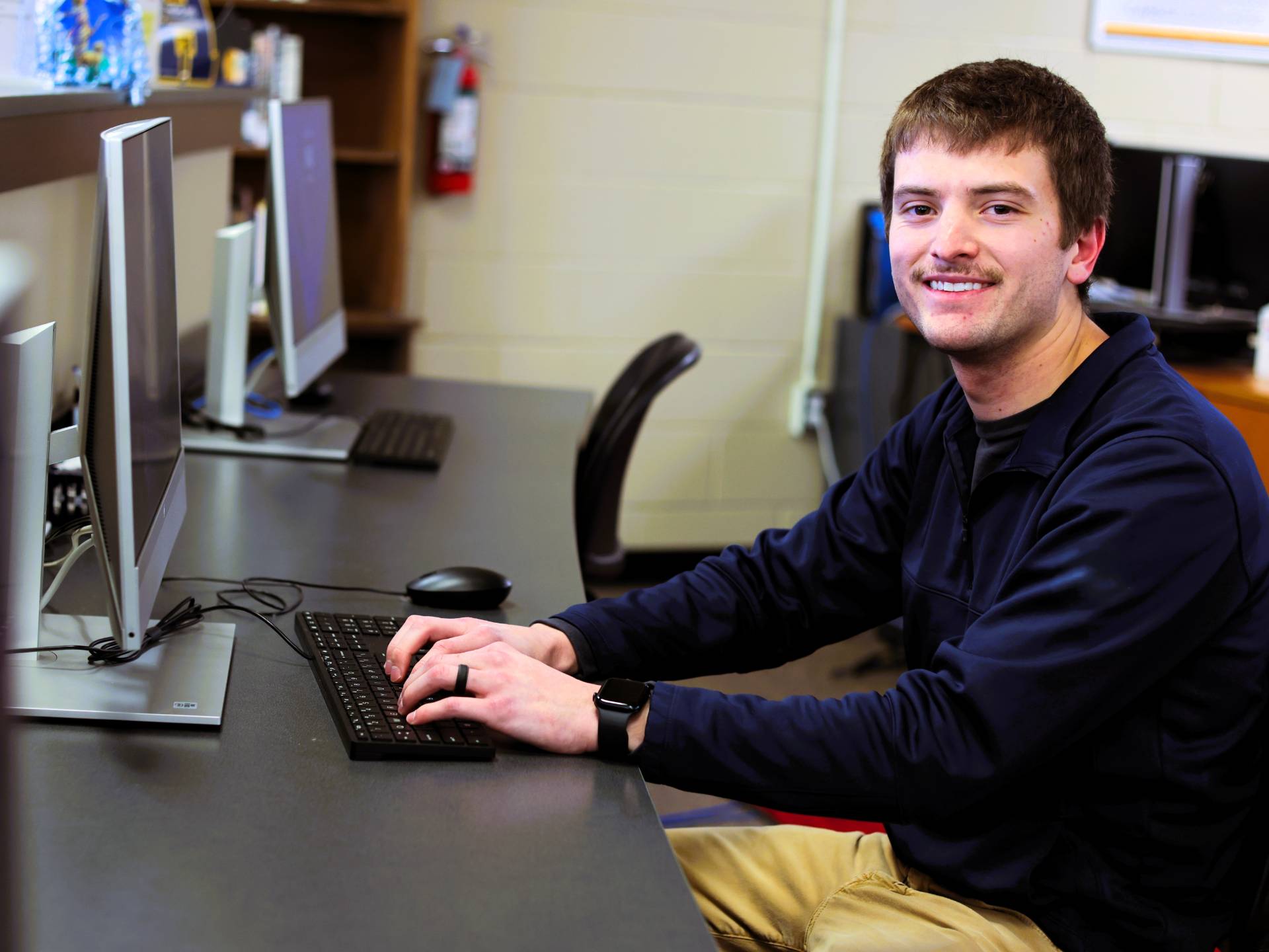 Student sitting at a computer.