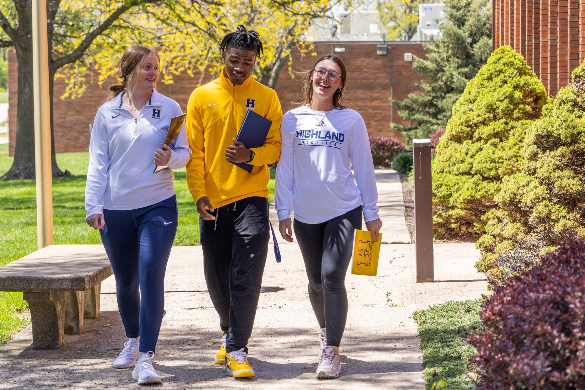 Three students walking on campus