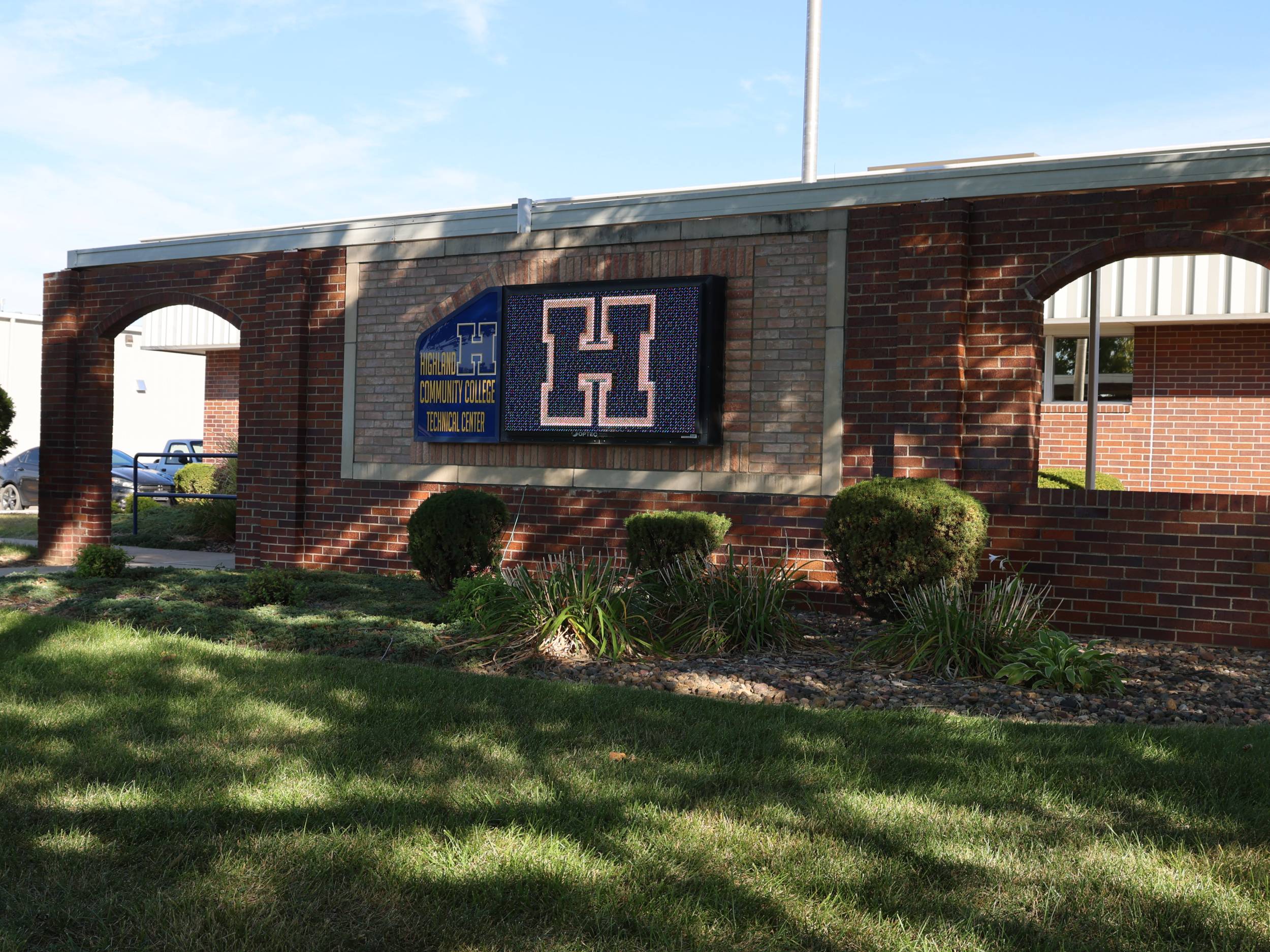 Highland Technical Center sign with brick entry and grass lawn.
