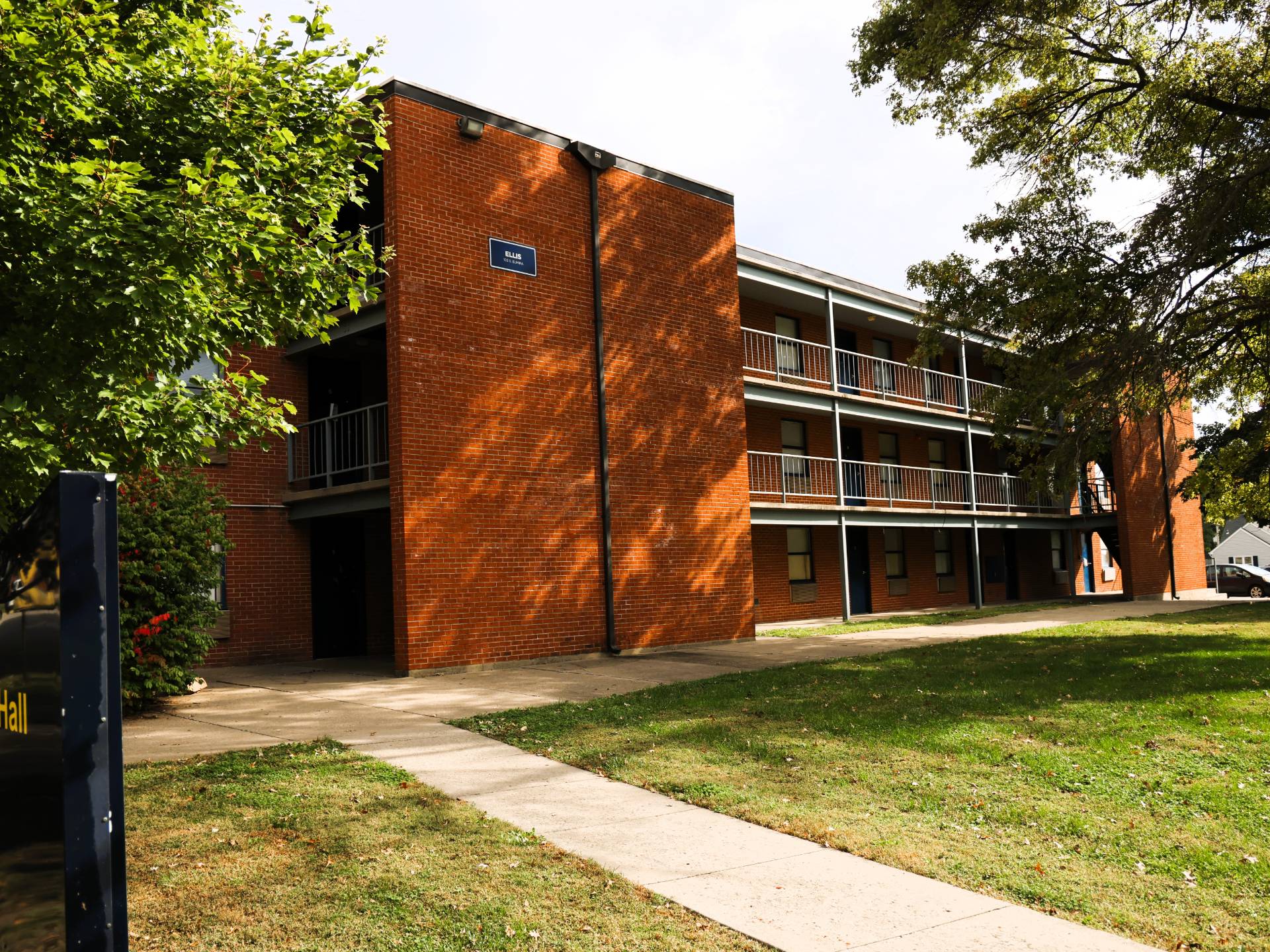 View of campus dorm, a tall brick building on a sunny summer day