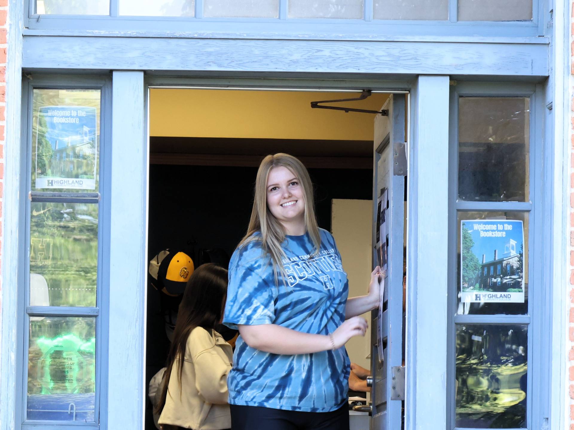 Student standing at the entrance of the bookstore
