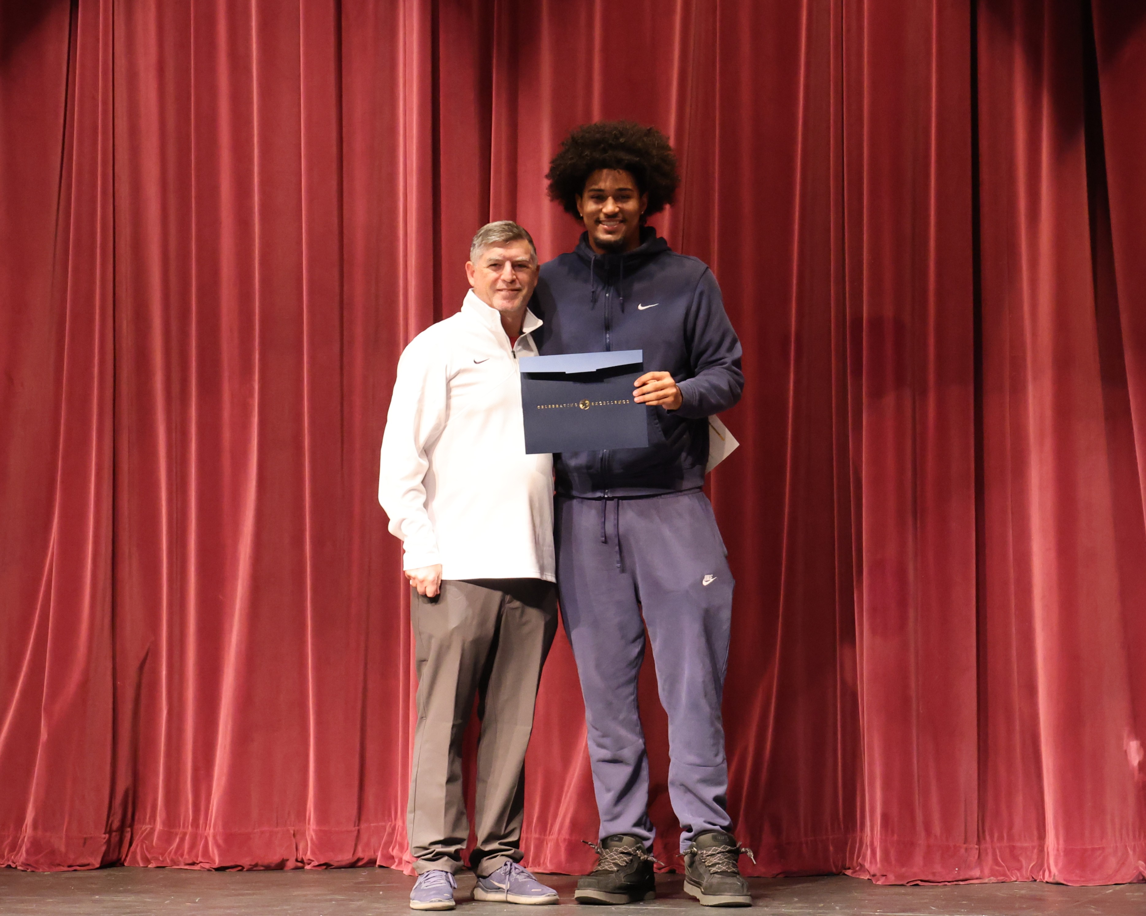 Athlete of the Year Award honors excellence in athletics and academics. Male recipient Tavian Tate is presented award by Coach Jon Oler